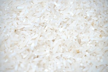 Dry Uncooked White Rice Background - Top View, Flat Lay. Scattered Raw Long Grain Rice. Asian Cuisine and Culture. Healthy Eating Ingredients. Diet Food