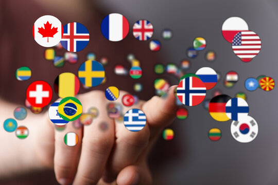 A hand interacting with a collection of international flags, representing global connection, travel, and unity. Perfect for themes of world, cul