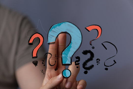 Hand holding question marks.  Uncertainty, doubt, problem solving, questions, answers, solution, concept, ideas.