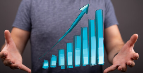 Stock photo of a man showcasing upward trending bar graph, symbolizing growth, success, and...