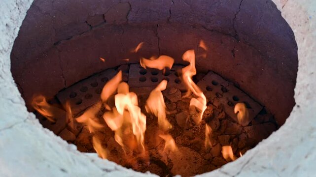 Flames inside of a tandoor oven as it heats up in Mary, Turkmenistan