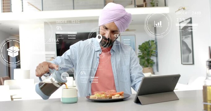 Mid-adult man pouring coffee at island glancing at tablet causing finance overlays growing near mug