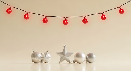 Silver christmas ornaments and red string lights on beige background for holiday season decoration