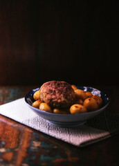 Fried meatballs with potatoes on a rustic background. Selective and soft focus.	