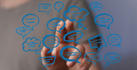 Hand touching digital chat bubbles representing communication and connection. Concept of technology, social med