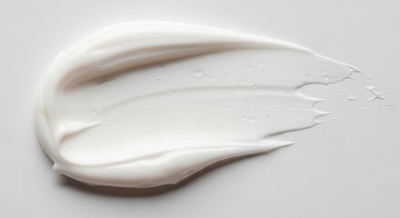 Applying smooth white cream on a surface studio setting product photography minimalist background close-up view skincare concept