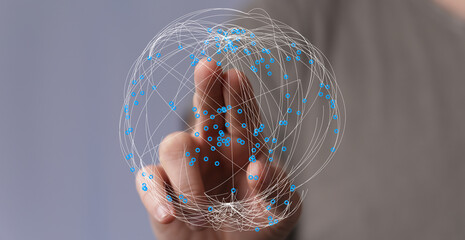 Hand touching a sphere of light, representing global connection, technology, and networks. Concept of the internet, innovation, and d