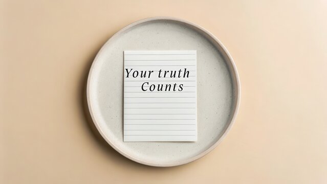 A Simple White Plate Holding a Notepad With the Message 'Your Truth Counts' Displayed