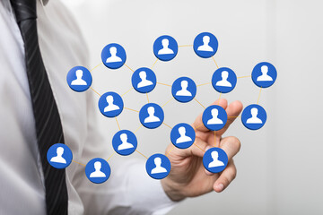 Business professional holding a network of people icons, representing social networking, teamwork, and global c