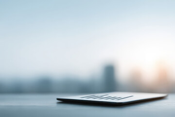 tablet displaying detailed budget plan with ar figures and blurred white text bars in background