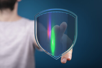 Hand holding a futuristic digital shield, symbolizing data protection and security. Perfect for...