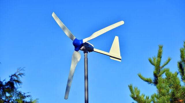 Wind turbine on blue sky. Concept of clean energy. Green technology for future.