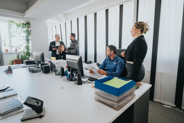 Professional team members discuss and plan tasks in an open office with modern decor.