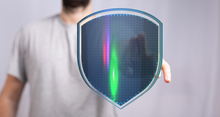 A person holding a futuristic shield with a digital, glowing interface. Concept of data security, protection, and online safety. Idea