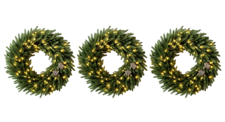 Three illuminated christmas wreaths with warm white lights on a dark background