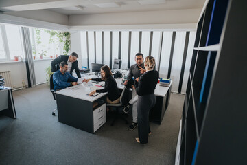 Professional team engaging in productive discussions and desk work at an office space. The collaborative setting reflects a modern and effective workplace culture promoting teamwork and efficiency.