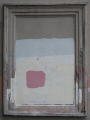 A rectangular frame on an old plastered wall
