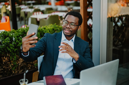 African american man video calling, working remotely