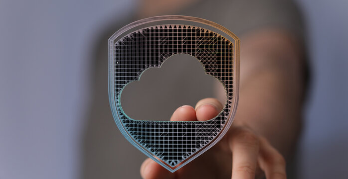 Abstract cloud security concept with a hand holding a digital cloud shield for data protection and safety. - Powered by Adobe