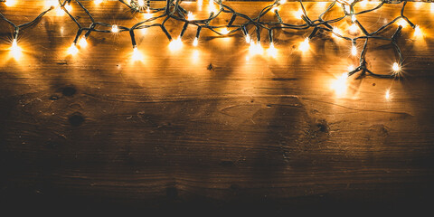 Warm Christmas Lights on Rustic Wooden Background
