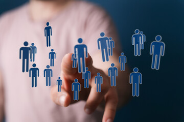 Hand touching floating human icons symbolizing technology networking and teamwork for business and social media