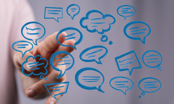 Hand touching speech bubbles, representing communication, social interaction, thoughts and ideas