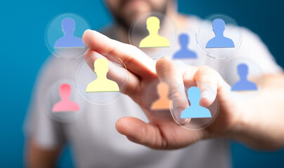 Hand reaching out to touch digital icons of people, representing connection, networking, and the concept of human interaction in a digital age.