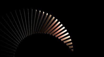 Intricate metal fan structure illuminated by warm light against a dark background