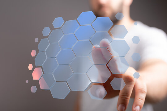 Abstract image of a hand interacting with a futuristic hexagon grid interface.  Perfect for tech, innovation, and connection concepts. - Powered by Adobe