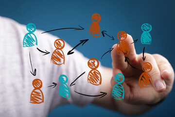 Human hand interacts with a virtual network of diverse people icons. Captures digital communication, teamwork, organizational structure, and soc