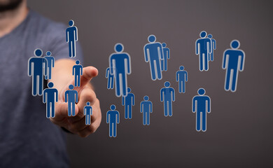 Hand reaching towards a cluster of digital people icons, representing communication, teamwork, and the network