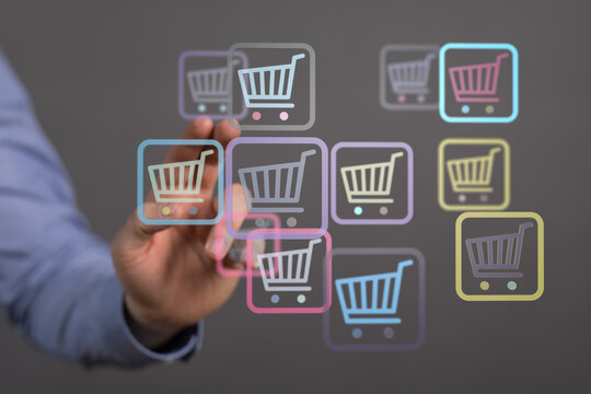 Hand touching digital shopping cart icons, symbolizing online shopping, e-commerce, and the digital marketplace. Perfect for illustrating buying