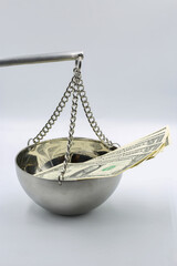 Money and justice concept with dollar bills on scale closeup.