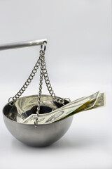 Money and justice concept with dollar bills on scale closeup.