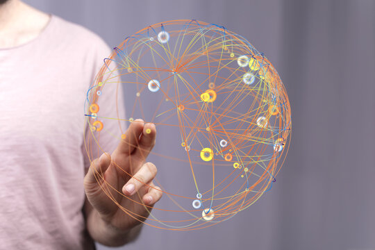 Close-up of a hand touching a 3D digital globe representing interconnected networks and global communication, innovation, and technol
