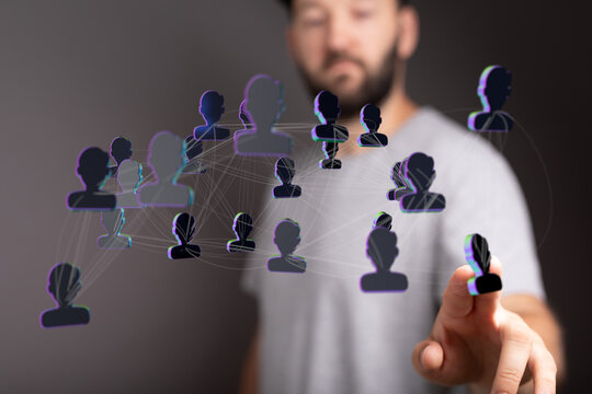 Man touching a digital interface representing a connected network of people, symbolizing teamwork and communica