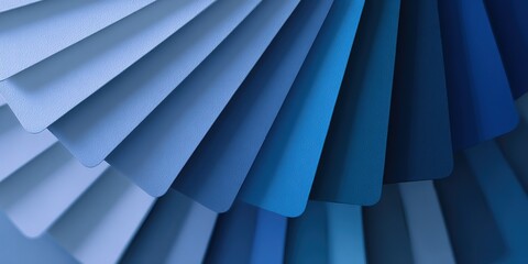 Colorful display of paint samples in various shades of blue arranged in a fan pattern at a design studio