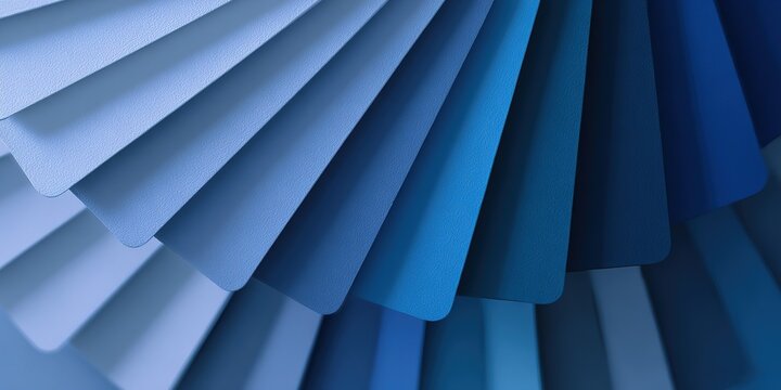 Colorful display of paint samples in various shades of blue arranged in a fan pattern at a design studio
