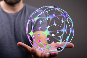 Close-up of a hand holding a glowing colorful network sphere, representing connection, technology,...