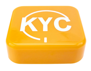 An eye-level, isolated view of a rounded square block, made of yellow plastic with white text and a circle design