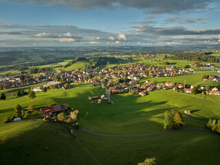 Aerial photo at sunset of the village of Weiler-Simmerberg, district Simmerberg in the western Allgaeu in Bavaria, Germany