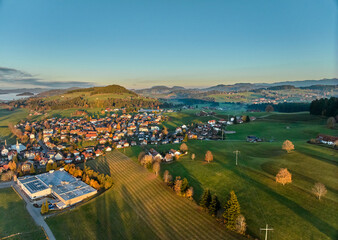 Aerial photo at sunset of the village of Weiler-Simmerberg, district Simmerberg in the western Allgaeu in Bavaria, Germany