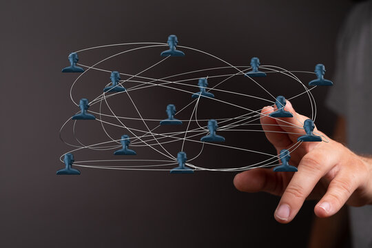 Abstract image of hand interacting with a network diagram illustrating connectivity, teamwork, and global communication.