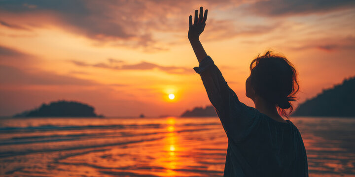 Woman embracing sunset on beach, hand raised in celebration of freedom and adventure