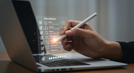 Professional business person digitally checks off tasks on futuristic holographic checklist with stylus on modern laptop screen, enhancing productivity and planning.