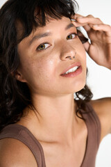 Fototapeta premium Stylish young woman showcases confidence with a charming smile and trendy attire