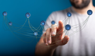 Close-up of a hand interacting with a network diagram illustrating concepts of connection, data, and technology