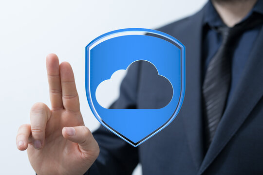 A business professional in a suit gestures towards a cloud data shield, symbolizing security and protection in