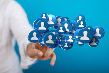 Hand reaching towards a network of people icons, representing social connections, teamwork, and digital interaction on a blue background.