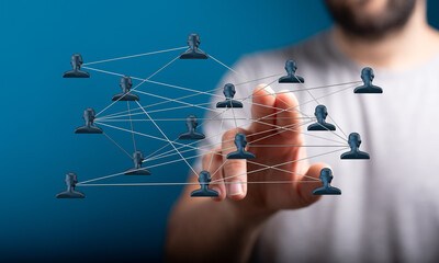 Visual of a person's hand interacting with a network of people, representing connectivity, networking, and digital communication, and social med